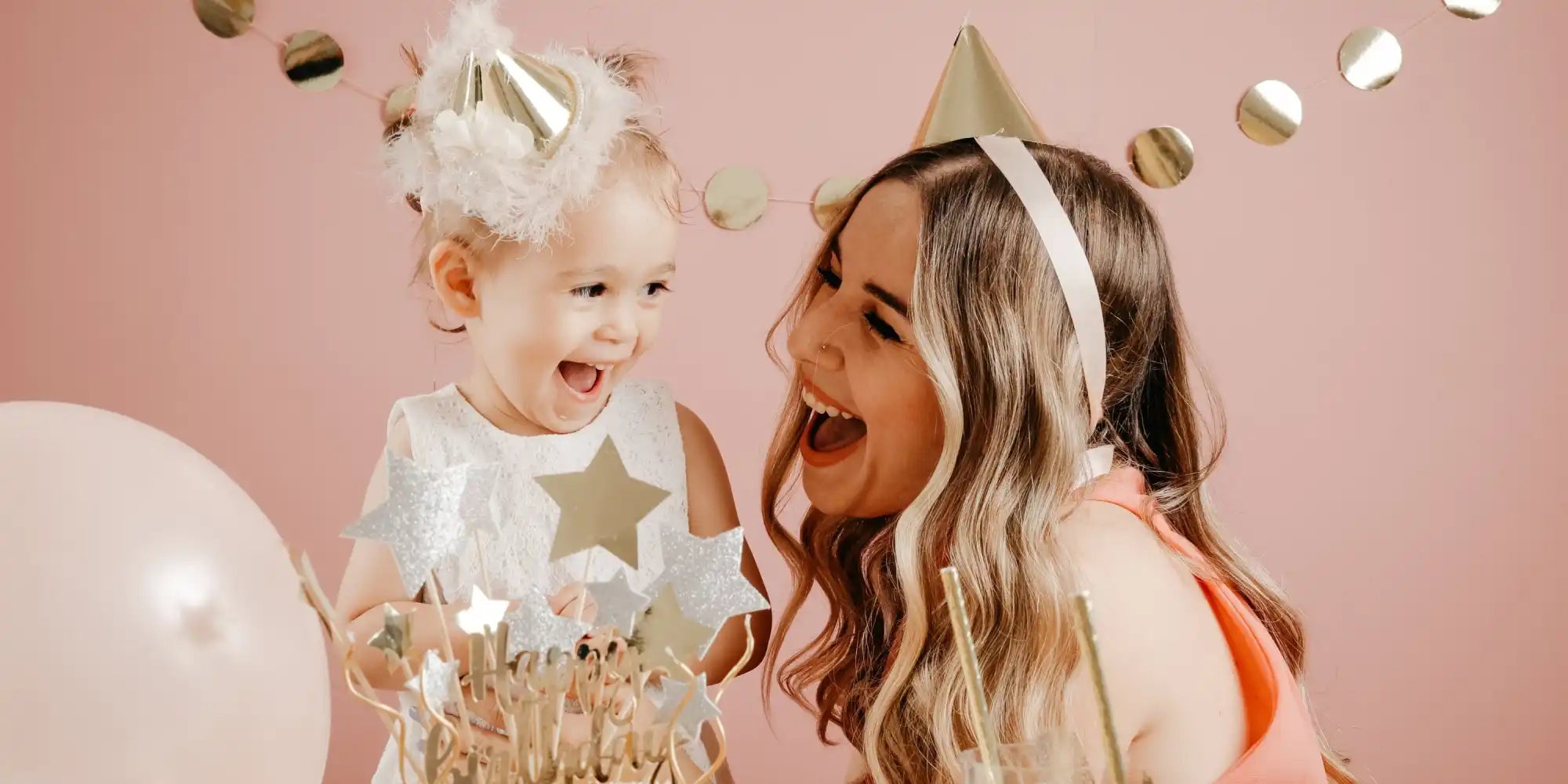 Two people with party hats and festive decorations.