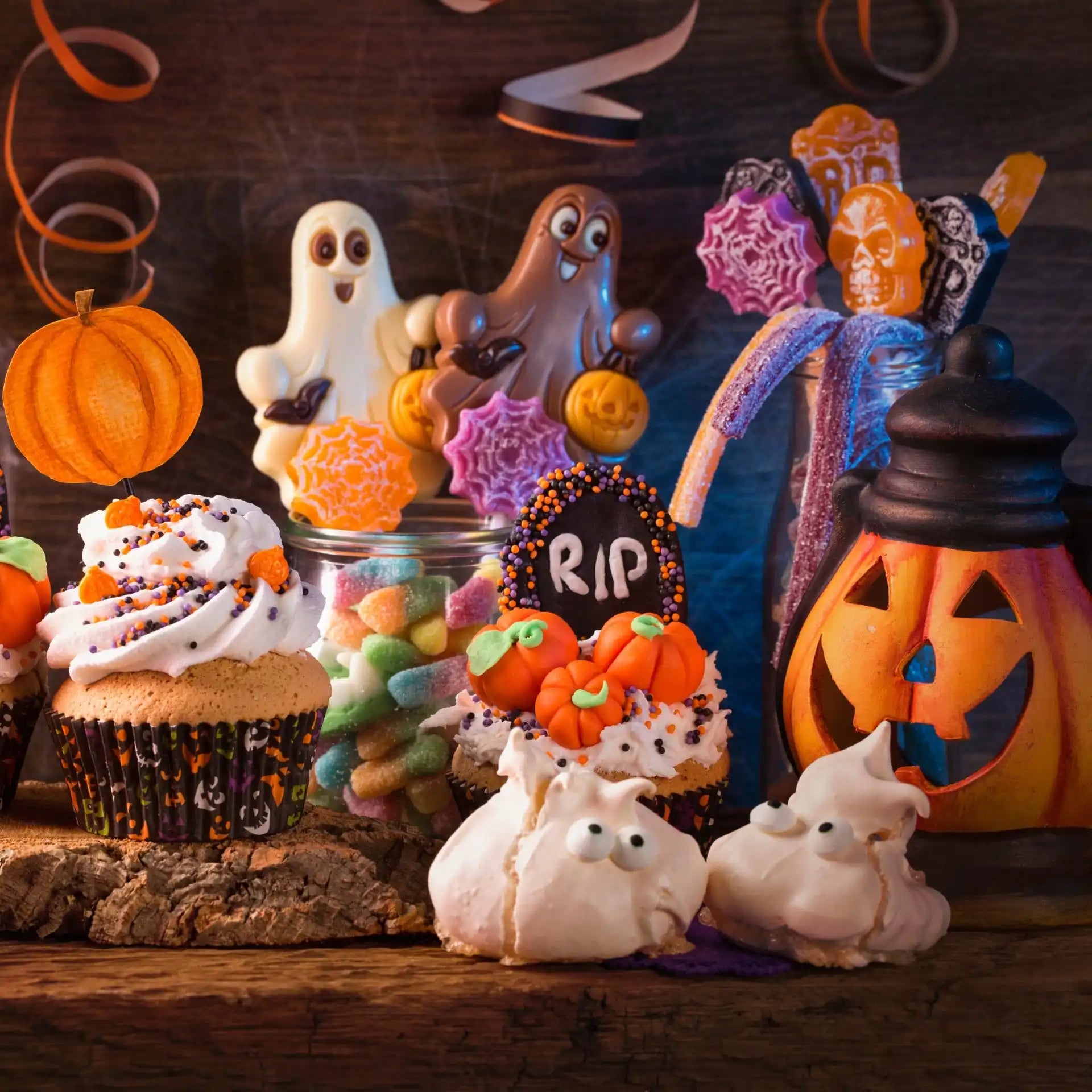 An assortment of Halloween-themed candies and baked goods.