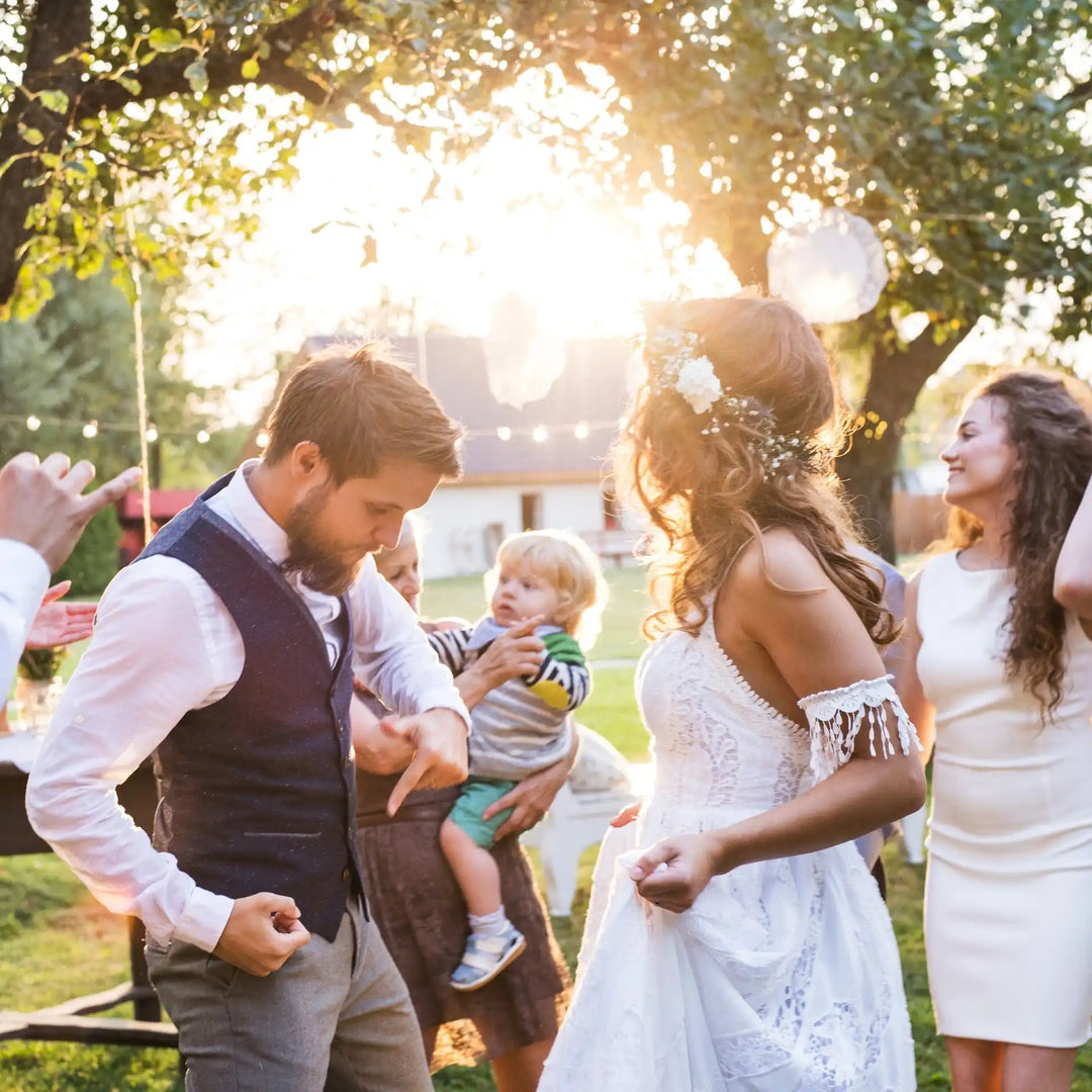 A couple dancing at an outdoor wedding.