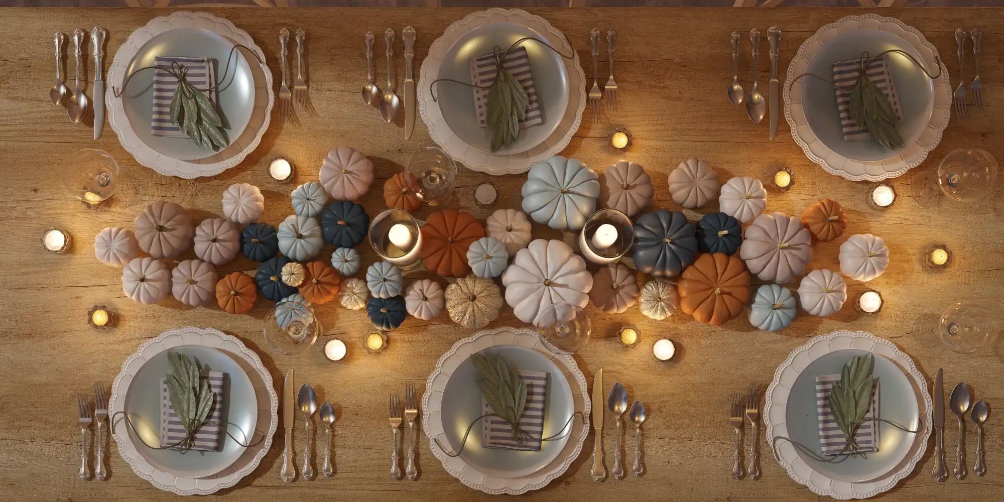 A festive holiday table setting with multiple place settings and a centerpiece of decorative pumpkins and candles.