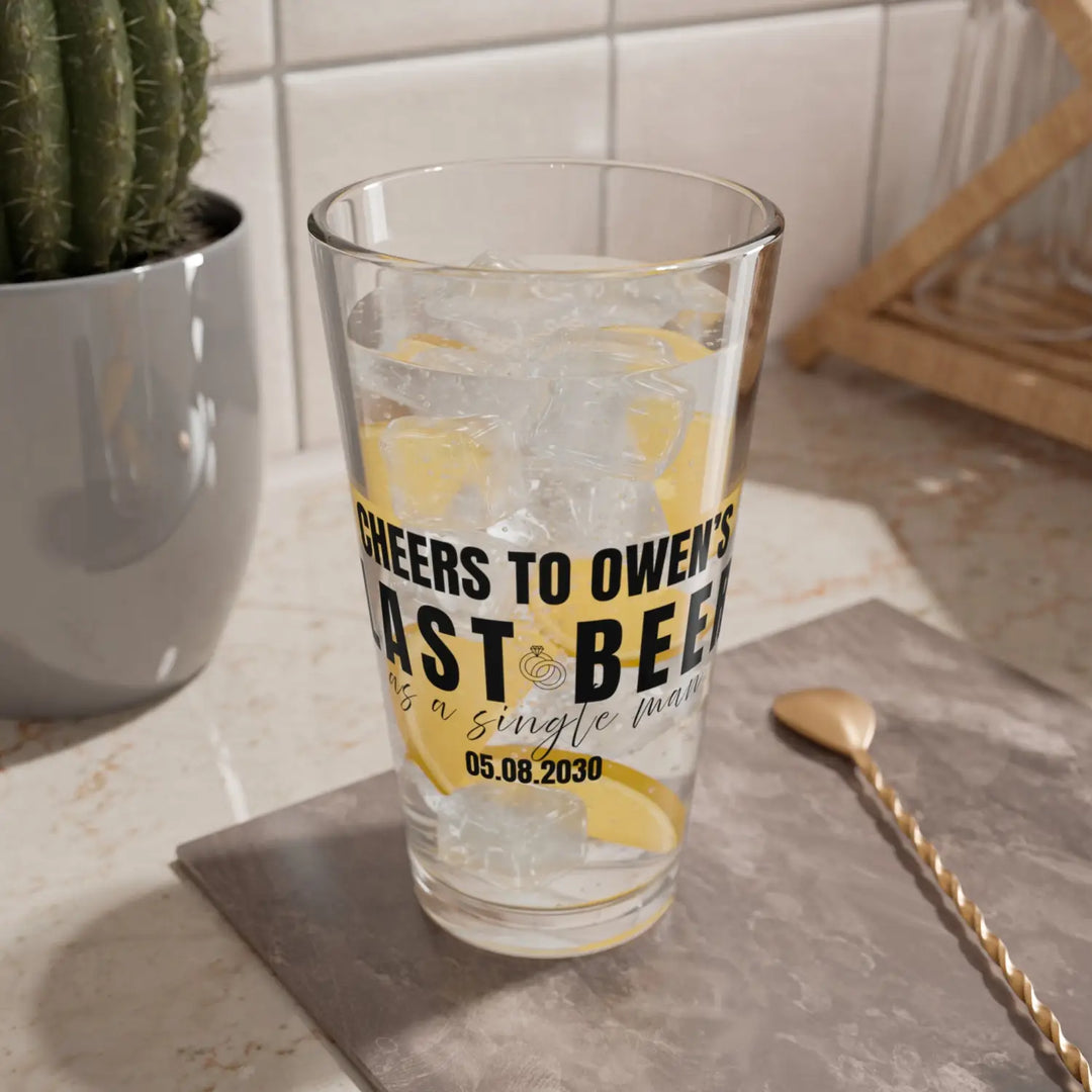 Personalized groom gift pint glass featuring ’last beer as a single man’ in black calligraphy with name and wedding