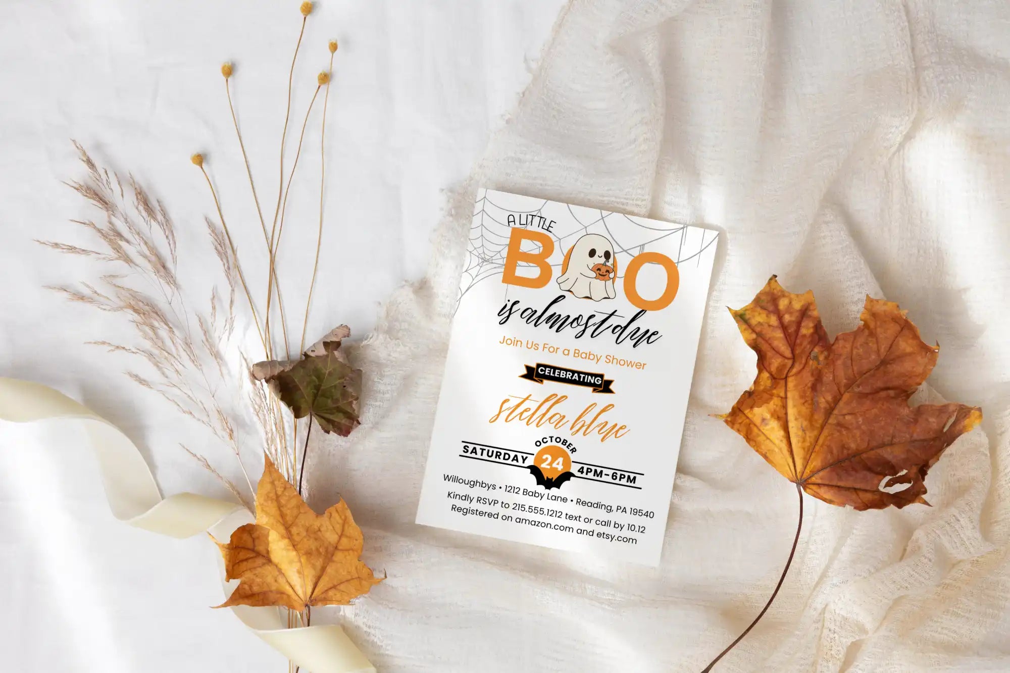 A Halloween-themed baby shower invitation featuring a ghost and autumn leaves